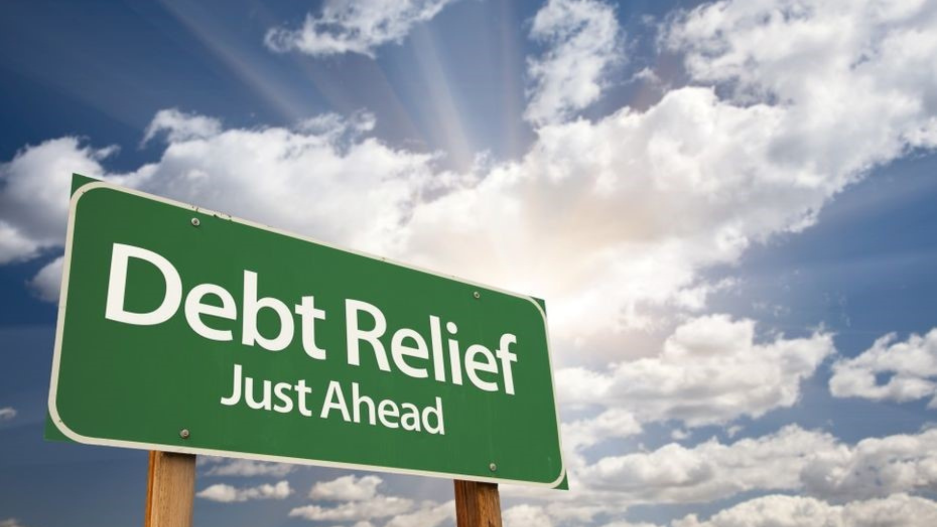 sign stating “debt relief just ahead”